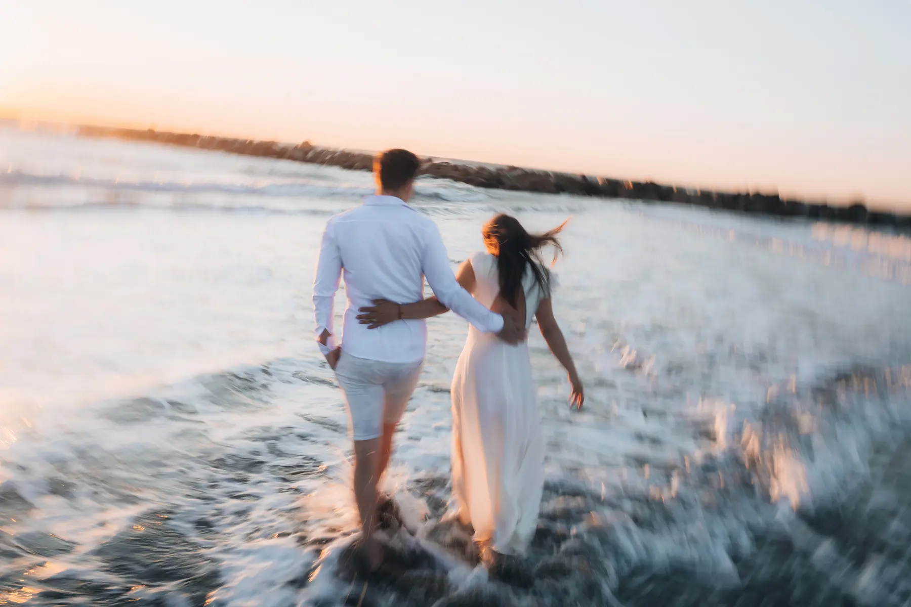 Pareja caminando junto al mar